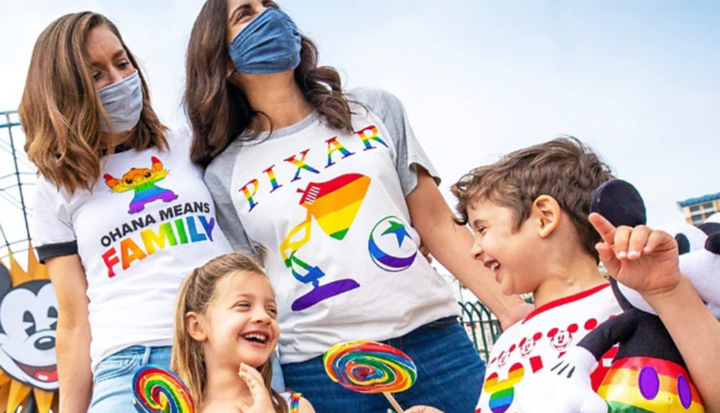 A family of 4 wearing Pride LGBTQ+ apparel  