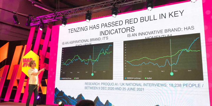 Tenzing, marketing, giving a brand speech on stage about how they use AI to improve performance, mentioning red bull